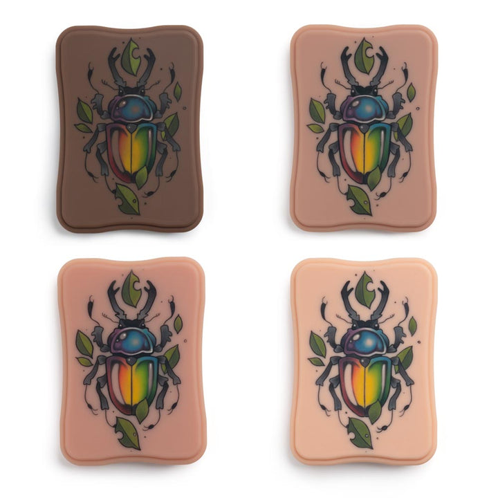 A Pound of Flesh Micro Series Tattooable Synthetic Small Square Plaque in all skin tones with example tattoo