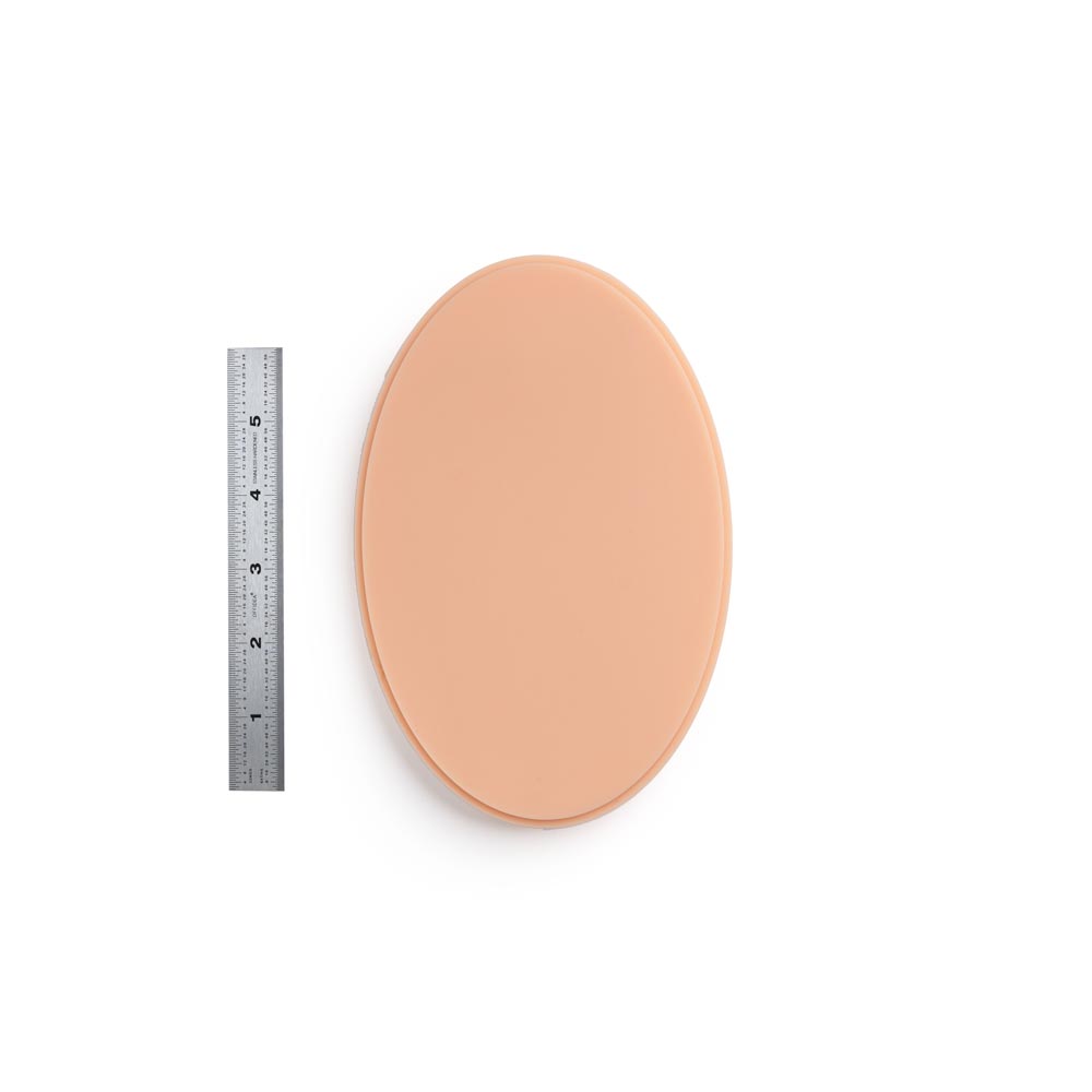 A Pound of Flesh Micro Series Tattooable Synthetic Small Oval in Fitzpatrick Tone 2 shown with ruler for scale