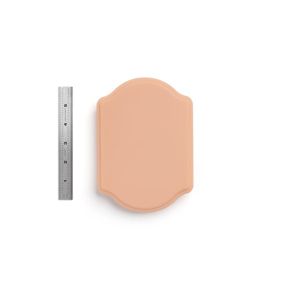 A Pound of Flesh Micro Series Tattooable Synthetic Small Plaque in Fitzpatrick Tone 2 shown with ruler for scale