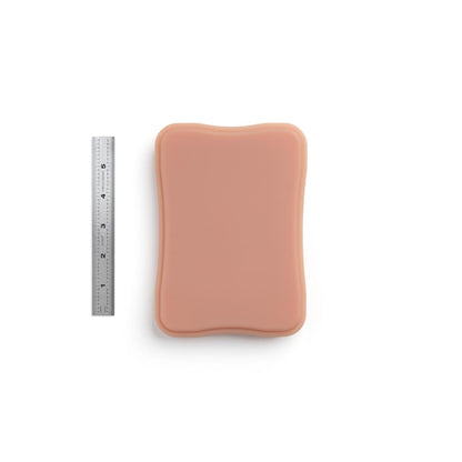 A Pound of Flesh Micro Series Tattooable Synthetic Small Square Plaque in Fitzpatrick Tone 3 shown with six inch ruler for scale