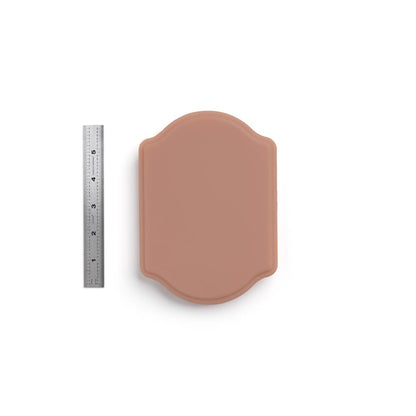 A Pound of Flesh Micro Series Tattooable Synthetic Small Plaque in Fitzpatrick Tone 4 shown with six inch ruler for scale