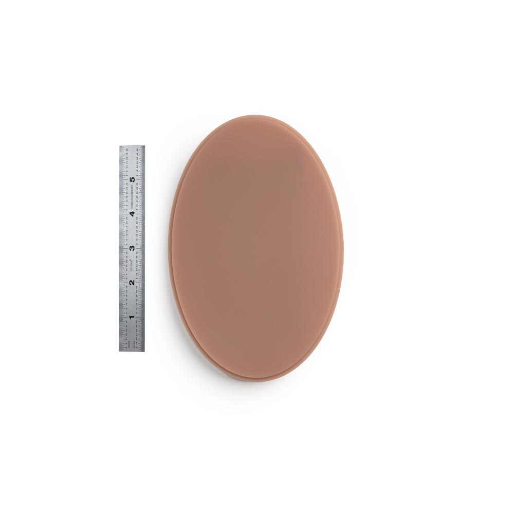 A Pound of Flesh Micro Series Tattooable Synthetic Small Oval in Fitzpatrick Tone 4 shown with six inch ruler for scale