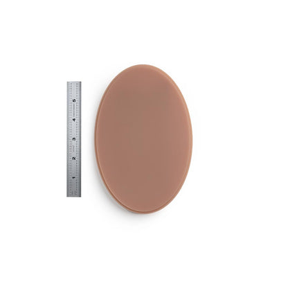 A Pound of Flesh Micro Series Tattooable Synthetic Small Oval in Fitzpatrick Tone 4 shown with six inch ruler for scale