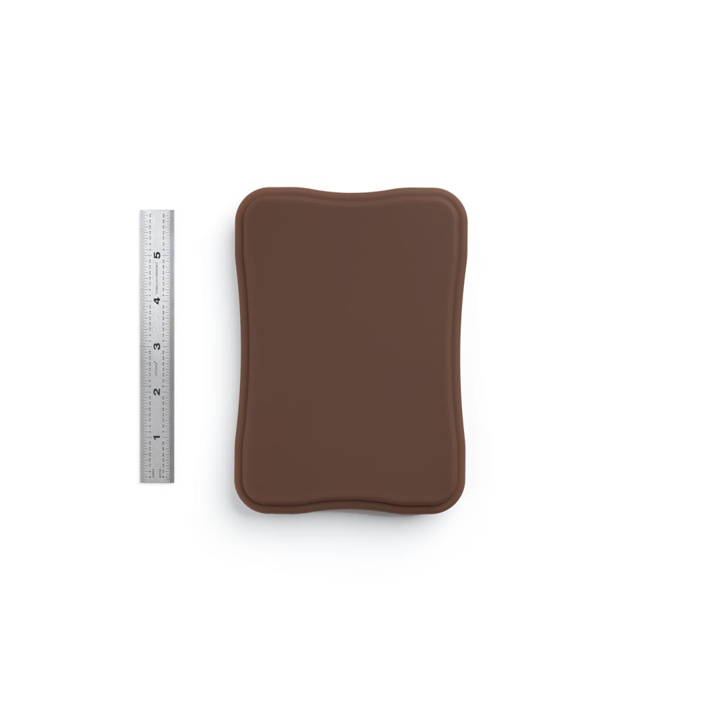 A Pound of Flesh Micro Series Tattooable Synthetic Small Square Plaque in Fitzpatrick Tone 5 shown with six inch ruler for scale