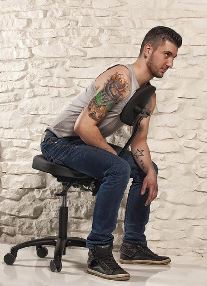 Precision Professional Tattoo Stool - Lifestyle Image Client Leaning Forward